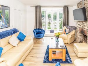 a living room with a couch and a table at 3 Mount Pleasant-uk36650 in Looe