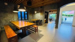 a dining room with a wooden table and benches at SOLO INN in Cochin