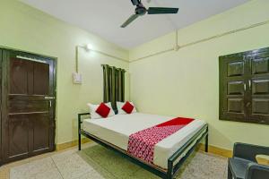 a bedroom with a bed with red pillows and a door at Flagship The Moon Palace in Patna
