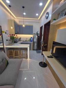 a kitchen and living room with a couch and a table at BMF Homestay Jacuzzi in Tacloban +21 photos