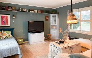 A television and/or entertainment centre at Beautiful Home In Lindesnes With House Sea View