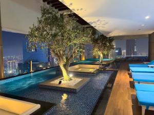 a pool with a tree on the roof of a building at Burj Khalifa Views 2BR with Infinity Pool Downtown in Dubai