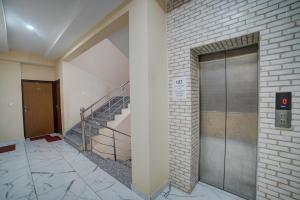 a building with a staircase and a metal door at HOTEL MADHAV INN in Haridwār