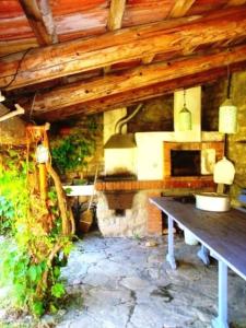 a room with a bench and a stone fireplace at Cottage a Bossolasco con piscina in Niella Belbo