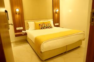 a bedroom with a large bed in a room at Hotel Hinduja Empire in Surat