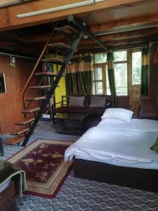 a bedroom with a large bed and a staircase at Jungle Crown Organic Homestay in Nagarkot