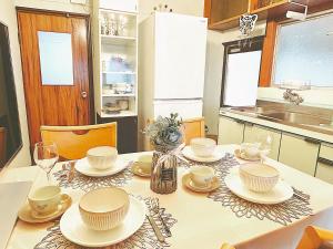 a kitchen with a table with dishes on it at Classy仏生山 in Takamatsu