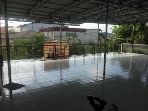 an empty tennis court with water on the floor at Orion Jaya House in Ketapang