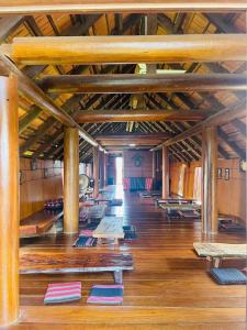a large room with wooden floors and wooden beams at Ban Me Central Hotel 2 in Buon Ma Thuot
