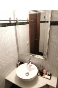 a bathroom with a white sink and a mirror at REST On The Pedestrian Street in Kalavrita +63 photos