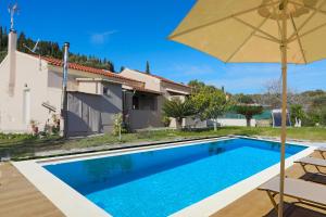 a villa with a swimming pool and a house at Villa Limoncello in Agrafoí