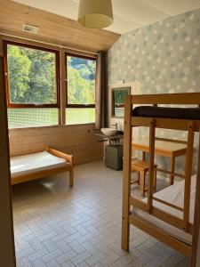 a room with two bunk beds and a sink at Serene Wilderness Getaway for 15 next to a historic castle 