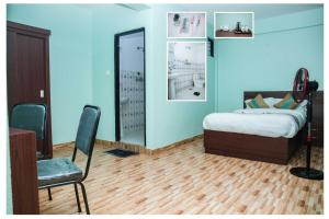 Postel nebo postele na pokoji v ubytování Yaksa Hotel Pvt. Ltd.