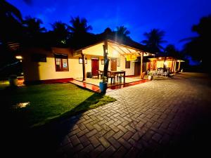 a small house with a patio at night at Green Sapphire Holiday Resort Wilpaththu in Wilpattu
