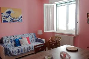 a living room with a couch and a table at Casa Rosa Marina di Cecina in Cecina