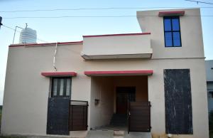 a white house with a water tank on top of it at Harisri Homestay in Madurai