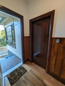 an empty room with a door and a window at Lyell Cottage Queenstown Comfortable and Warm in Queenstown
