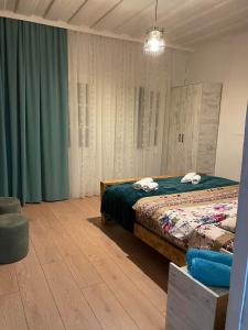 a bedroom with a bed with two towels on it at odahouse. fireplace and spring water. in Batumi