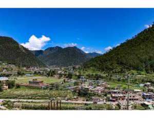 a town in a valley with mountains in the background at Hotel Chaar Vedas, Uttarkashi in Uttarkāshi