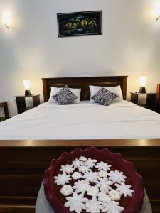a bedroom with a bed with white flowers on it at Sunrise oasis retreat in Habarana