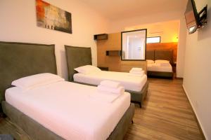 Postel nebo postele na pokoji v ubytování Ortus Rooms