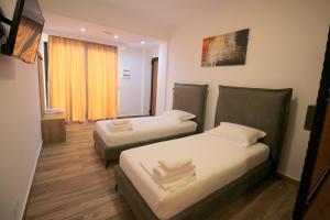 Postel nebo postele na pokoji v ubytování Ortus Rooms
