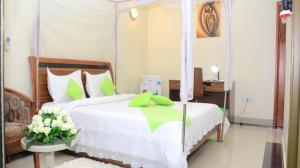 a bedroom with a bed with a canopy at KARIBA SUN BEACH APARTMENT in Rutsiro