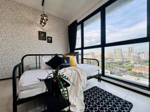 a bedroom with two beds and a large window at Cozy & Drive Urban Suite by WL in Jelutong +280 photos