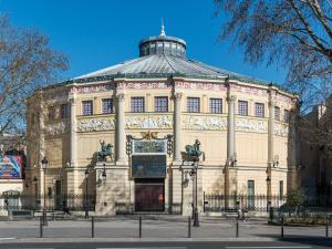 a large building with a sign in front of it at Le Saint Claude in Paris