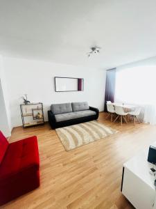 a living room with a couch and a table at Magnifique Appartment in Linz