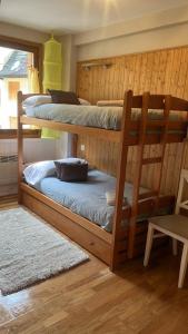 a room with three bunk beds in a cabin at Moncayo Canfranc in Canfranc-Estación