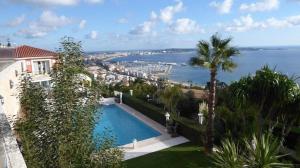 a swimming pool in a house with a view of the water at Yuca in Vallauris