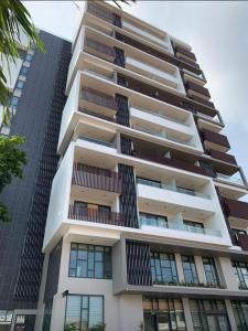 a tall building with balconies on it at Primahem solaris in Accra