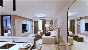 a large living room with a couch and a tv at Primahem solaris in Accra
