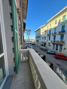 a balcony of a building with a view of a street at Appartamento Katy in Viareggio