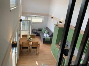 a living room with a couch and a table at Tinyhouse Wald(t)raum in Wilhelmsthal