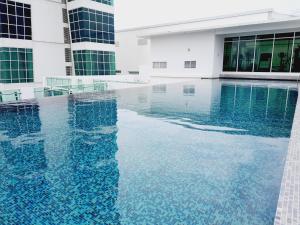 a swimming pool in the middle of a building at Fantastic Seaview Loft 2R2B 9Pax #Maritime in Jelutong
