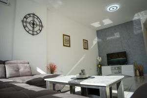 a living room with a couch and a table at Apartment Una Laguna in Bihać