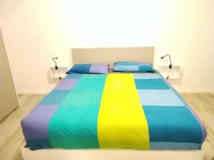 een bed met een kleurrijke deken erop bij Archidante in Bari