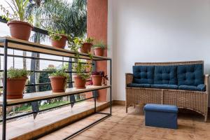 a room with a couch and potted plants at Sophie's World- 2 Bedroom luxury apartment in Lubowa