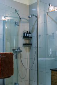 a bathroom with a shower with a glass door at Sophie's World- 2 Bedroom luxury apartment in Lubowa