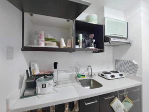 a kitchen with a sink and a counter top at Pico De Loro staycation in Nasugbu