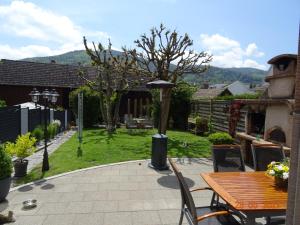 a patio with a table and chairs and a garden at Chez Michèle et Philippe in Munster