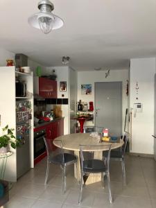 a kitchen with a table and chairs in a room at AppartCanet in Canet-en-Roussillon
