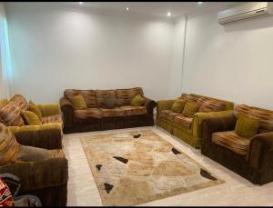 una sala de estar con 2 sofás y una alfombra en Alwaha-Appartement en Riad