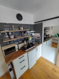 a kitchen with white cabinets and a counter top at Private self contained self catering flat in Bristol