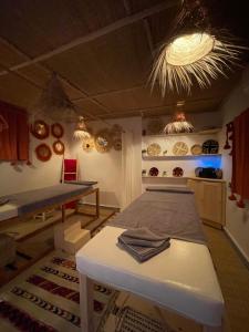 a room with a bed and a table in it at Riad La Calèche & SPA in Marrakesh