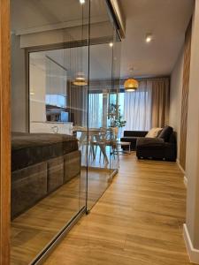 a bedroom with a large glass door leading to a living room at Apartament Laguna Beskidów - Zarzecze in Zarzecze
