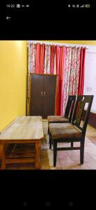 a room with a table and a bench and a chair at HOTEL CASTLE HOME STAY in Jaipur
