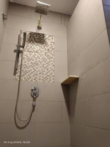 a shower in a bathroom with a tile shower at Swiss Hotel Heritage Boutique Melaka in Melaka